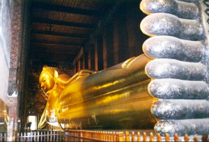 gold thai statue lying on its side